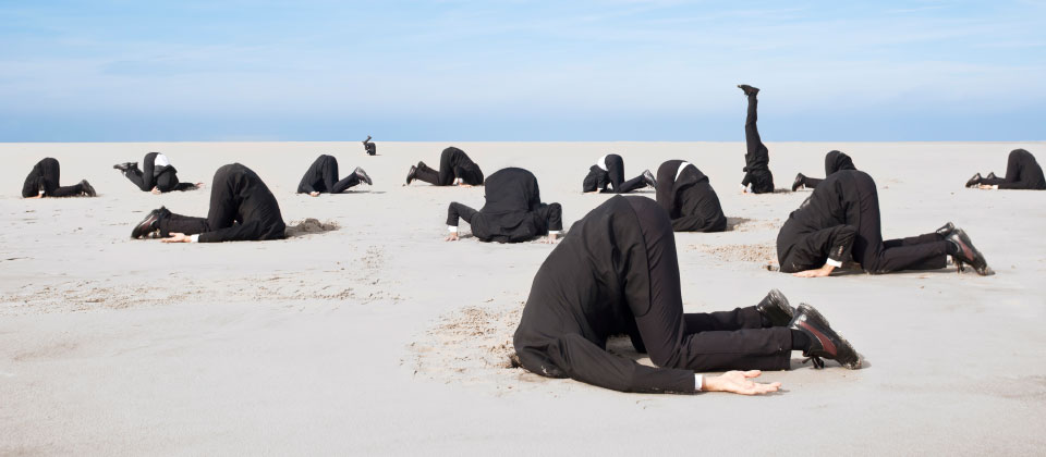 Employees in suits hide their heads in sand when a campaign doesn’t inspire or motivate