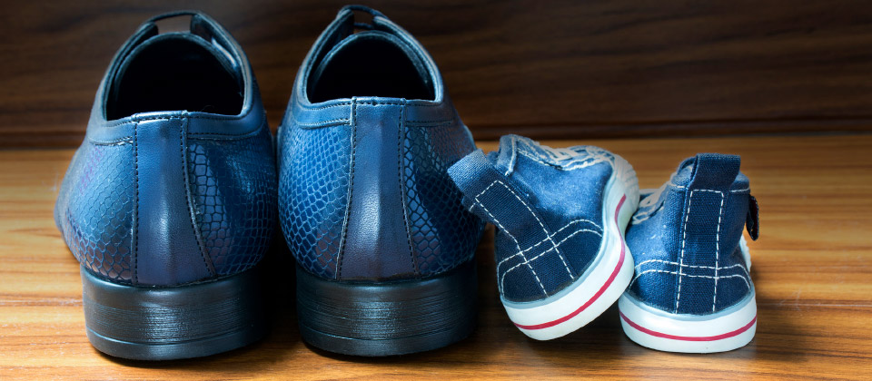 Work shoes and kids shoes to represent onboarding first impressions making a lasting impression